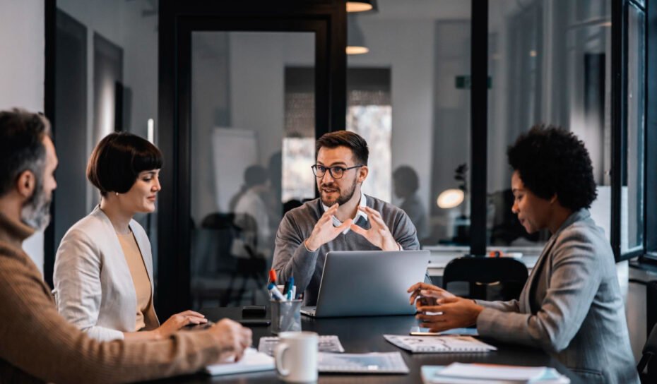 senior-manager-is-sitting-boardroom-with-multiracial-colleagues-discussing-project senior-manager-is-sitting-boardroom-with-multiracial-colleagues-discussing-project