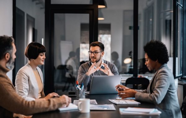 senior-manager-is-sitting-boardroom-with-multiracial-colleagues-discussing-project